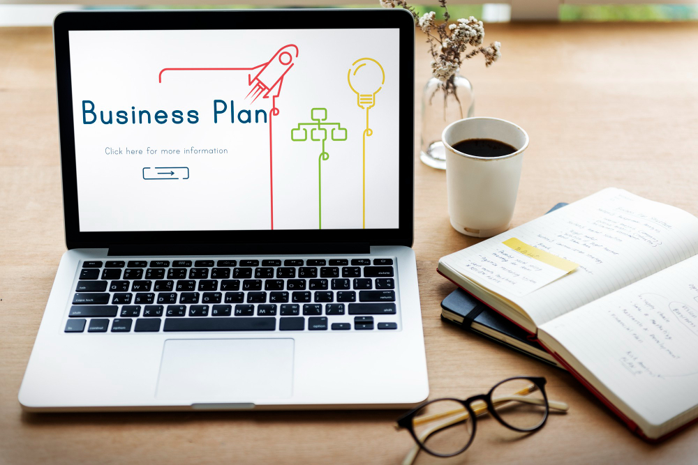 Business plan displayed on a laptop screen, showcasing graphs and text in a professional setting